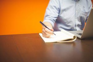 man taking notes during an osha training class