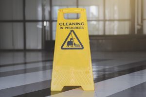 cleaning progress caution sign in office background