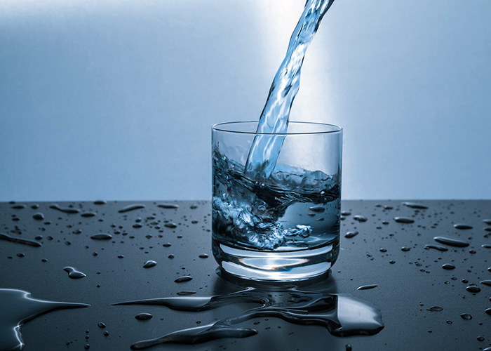 water poured into a cup on a wet table