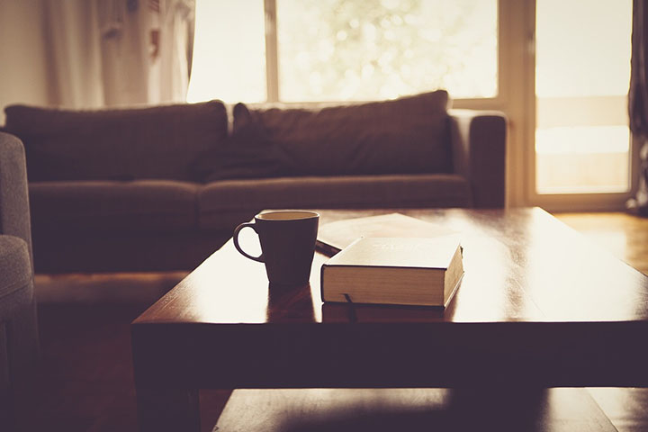 mug and book on a table in a living room with good indoor air quality