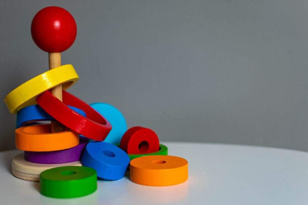 colorful childrens ring stack toy on a table, beware lead paint