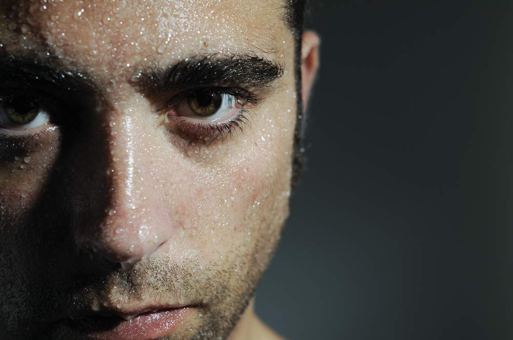 closeup of a man who is sweating profusely, dangers of heat stress